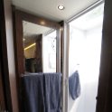 Shower door with mirror opens to close off bedroom area