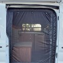 We've since replaced the side door screen with one from VanEssential.